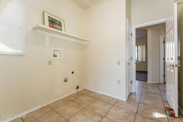 clothes washing area with laundry area, light tile patterned flooring, hookup for a washing machine, and hookup for an electric dryer