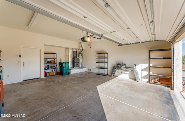 garage with a garage door opener and water heater