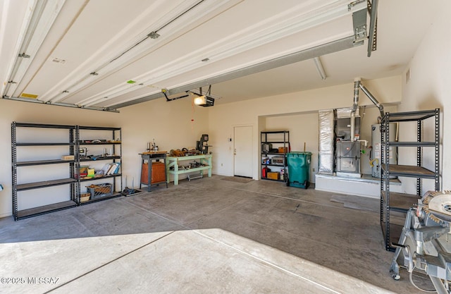 garage featuring a garage door opener, water heater, visible vents, and heating unit