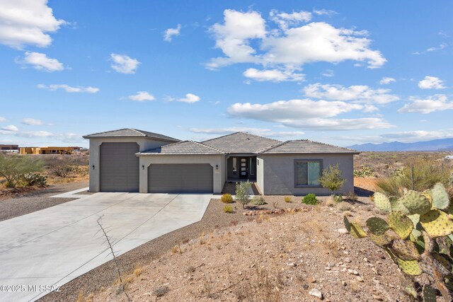 view of side of home with a gate and stucco siding