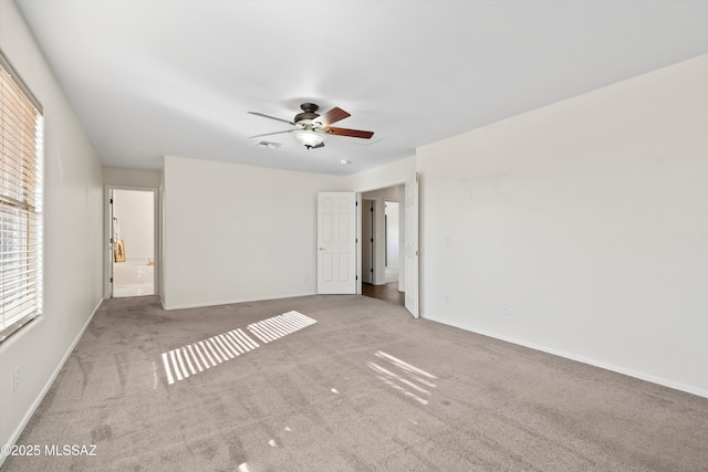 unfurnished bedroom featuring carpet floors, visible vents, ceiling fan, and baseboards