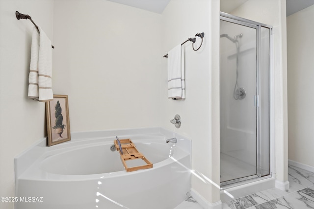 full bath with marble finish floor, a garden tub, and a stall shower