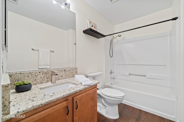 bathroom with shower / washtub combination, tasteful backsplash, toilet, vanity, and wood finished floors