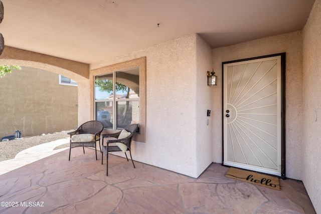 property entrance with stucco siding