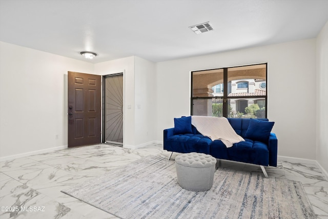 sitting room with marble finish floor, visible vents, and baseboards