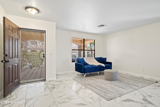 entrance foyer with marble finish floor, visible vents, and baseboards