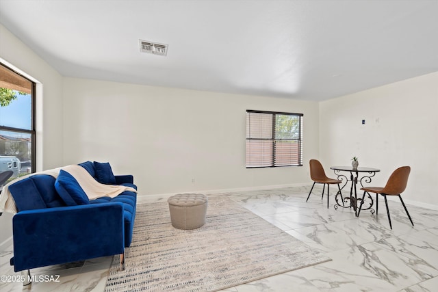 living area with marble finish floor, baseboards, and visible vents