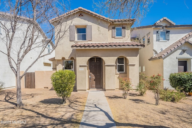 mediterranean / spanish-style house featuring a tile roof and stucco siding