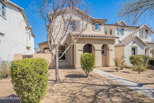 mediterranean / spanish-style house featuring a tile roof and stucco siding