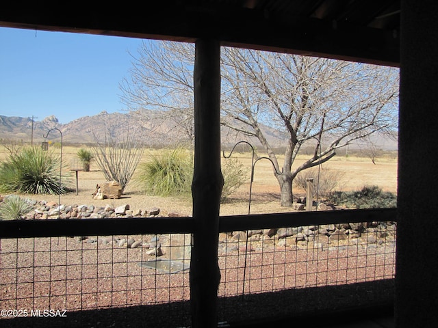 view of water feature with a mountain view and fence