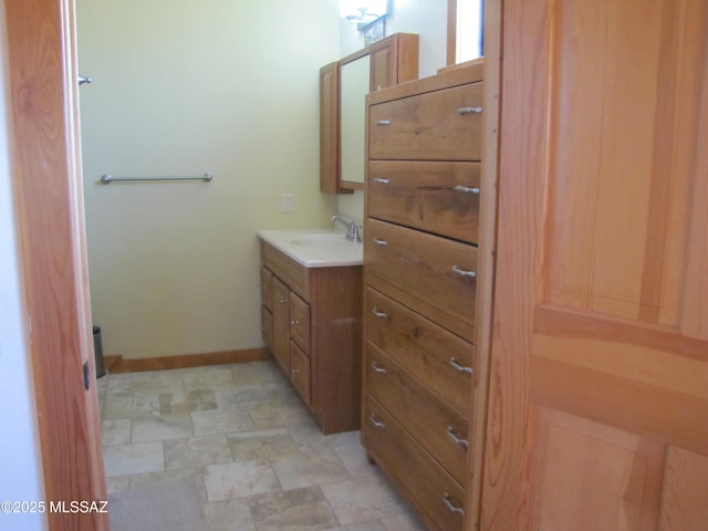 bathroom featuring vanity and baseboards