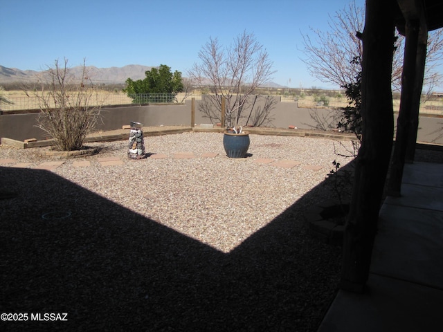 view of yard with a mountain view and a fenced backyard