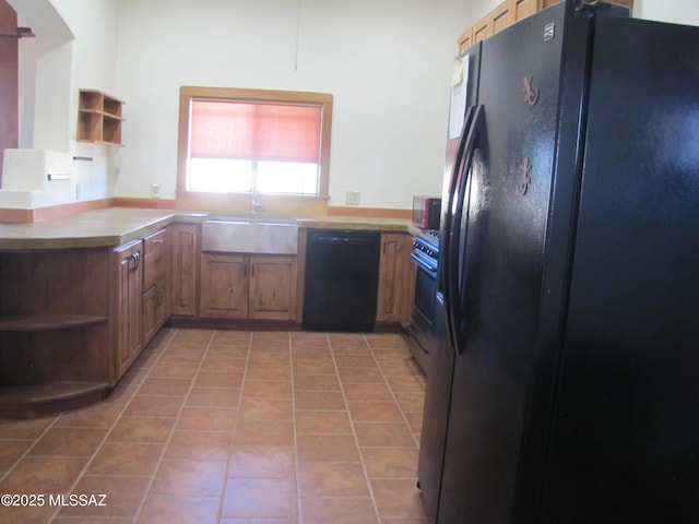 kitchen featuring light tile patterned floors, a sink, black appliances, and open shelves