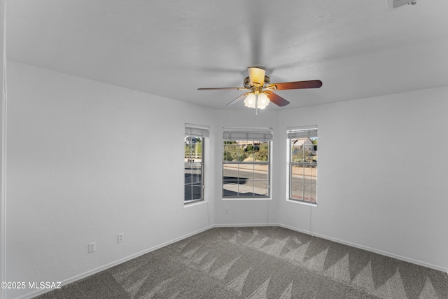 unfurnished room featuring baseboards, carpet, and a ceiling fan