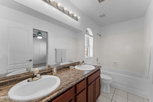 bathroom featuring tile patterned floors, shower / bathing tub combination, visible vents, and a sink