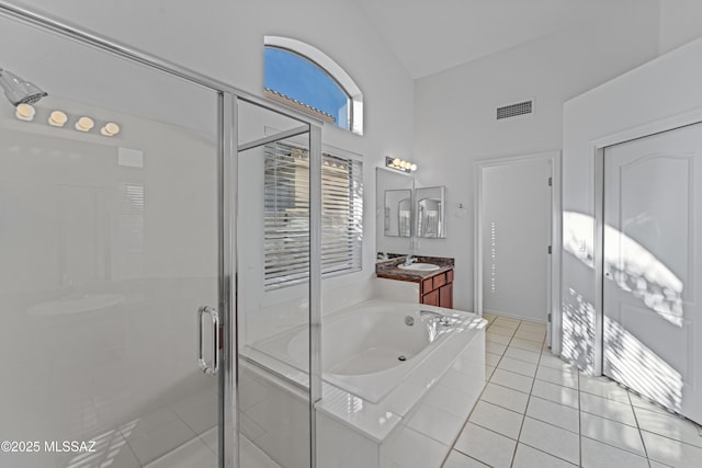 bathroom with tile patterned flooring, visible vents, a shower stall, and vanity