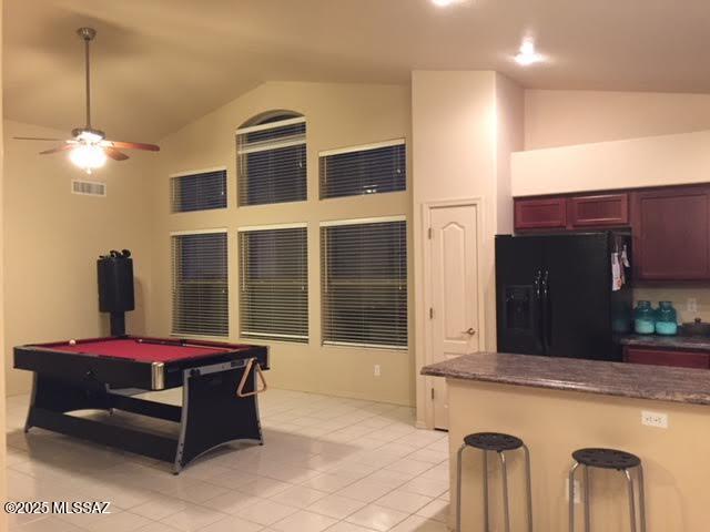 game room with visible vents, light tile patterned floors, high vaulted ceiling, billiards, and a ceiling fan