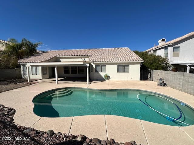 view of swimming pool featuring a fenced backyard, a fenced in pool, and a patio