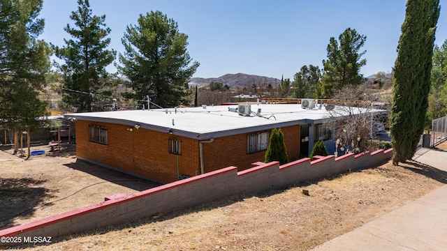 view of side of home with a mountain view and brick siding