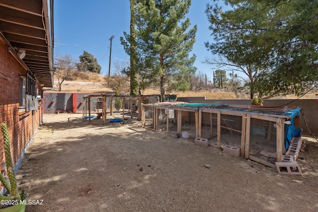 view of yard with exterior structure, an outdoor structure, and fence