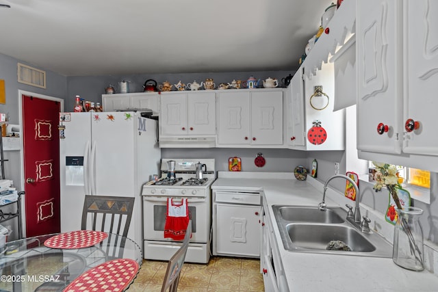 kitchen with white appliances, visible vents, a sink, light countertops, and under cabinet range hood