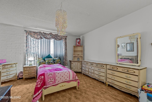 bedroom with carpet floors and a textured ceiling