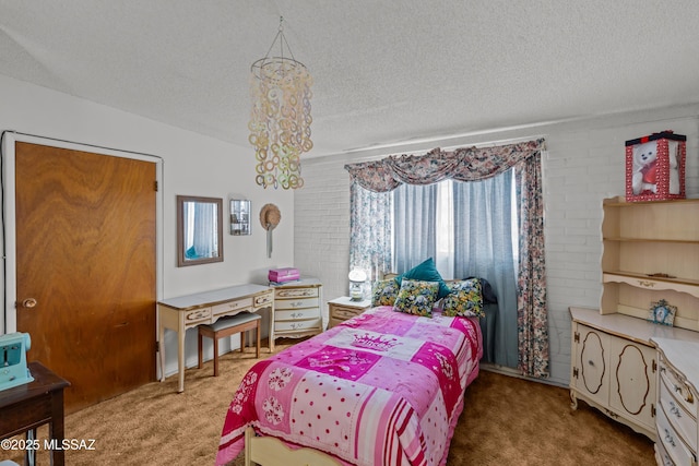 bedroom featuring a chandelier, a textured ceiling, and carpet floors