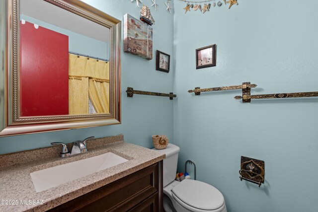 bathroom featuring toilet and vanity