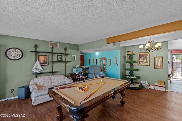 playroom with visible vents, baseboards, a textured ceiling, and wood finished floors