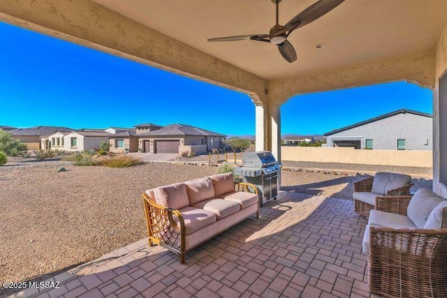 view of patio featuring an outdoor living space, fence, a residential view, area for grilling, and a ceiling fan