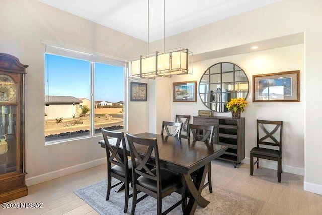 dining room featuring baseboards and light wood-style floors