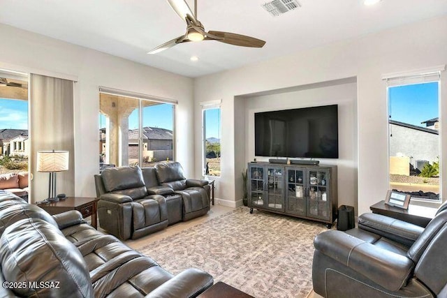 living area featuring recessed lighting, visible vents, baseboards, and a ceiling fan