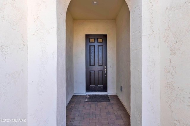 entrance to property with stucco siding