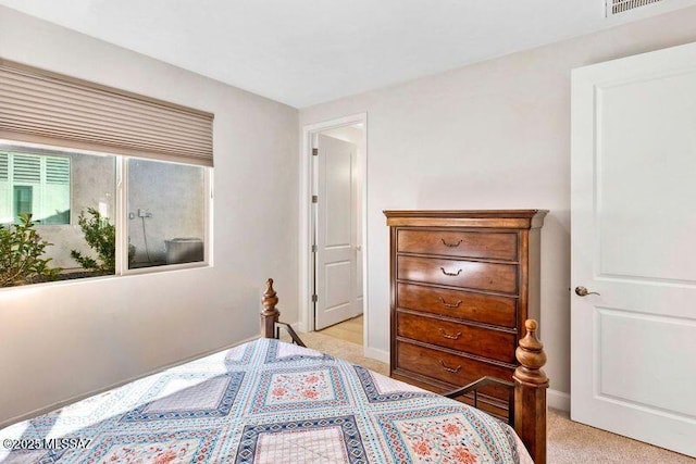 bedroom with visible vents, baseboards, and light colored carpet