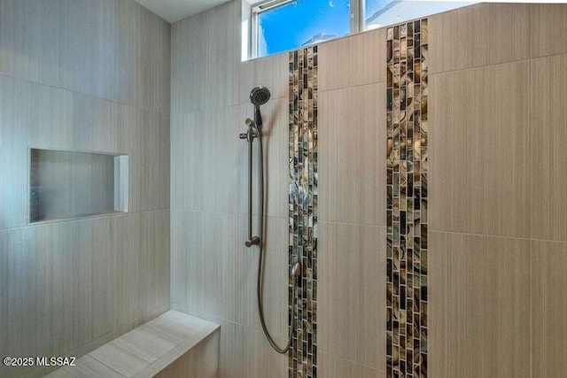 bathroom with a tile shower