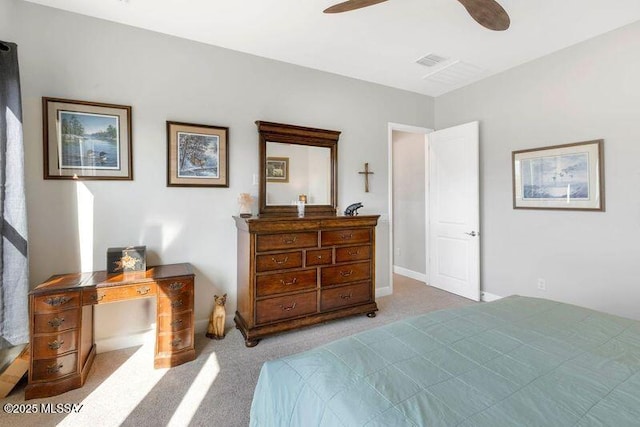 bedroom with visible vents, light colored carpet, and a ceiling fan