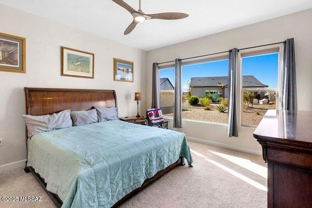 bedroom featuring ceiling fan, baseboards, and light carpet