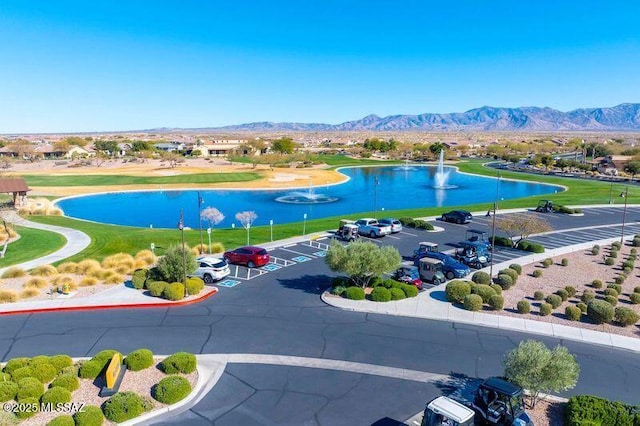 birds eye view of property with a water and mountain view