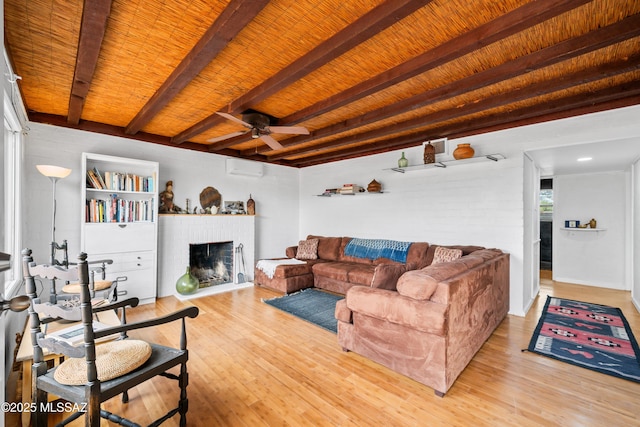 living room featuring beamed ceiling, light wood-style flooring, and a ceiling fan