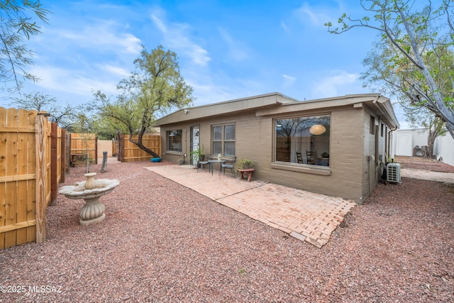 rear view of house featuring a patio area and a fenced backyard