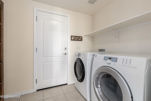 13827 E Fiery Dawn Dr, Vail, AZ 85641 - clothes washing area featuring light tile patterned floors, visible vents, baseboards, washer and dryer, and laundry area