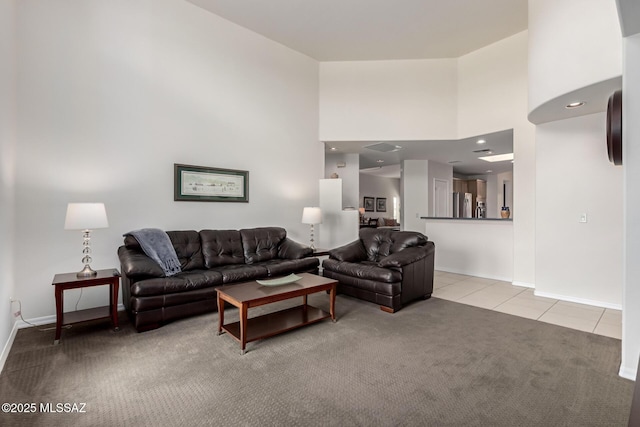 13827 E Fiery Dawn Dr, Vail, AZ 85641 - living room with recessed lighting, a high ceiling, light tile patterned floors, baseboards, and light colored carpet