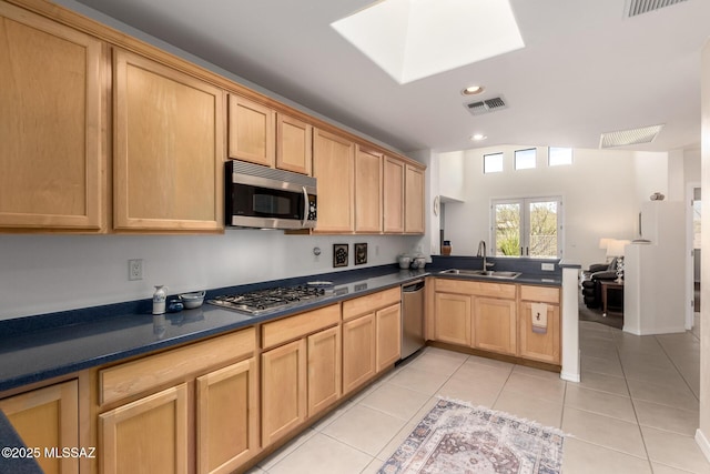13827 E Fiery Dawn Dr, Vail, AZ 85641 - kitchen featuring a sink, stainless steel appliances, light brown cabinetry, a peninsula, and a skylight