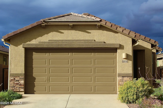 garage featuring concrete driveway