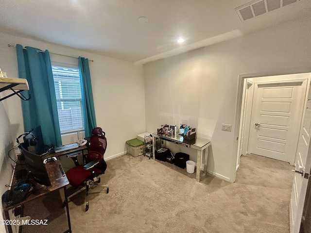 carpeted office featuring visible vents and baseboards