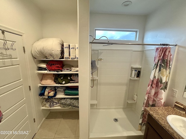 full bath with a shower with shower curtain, vanity, and tile patterned flooring