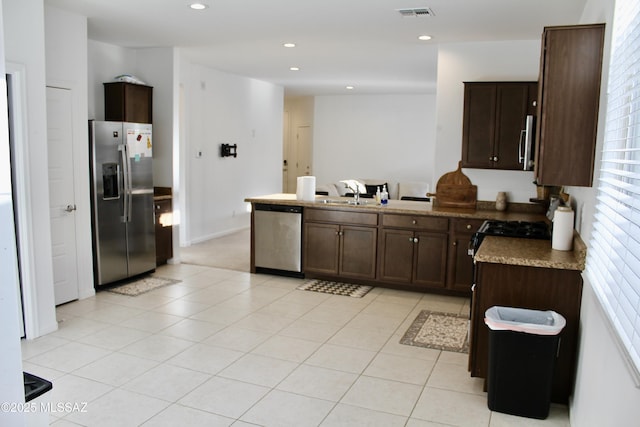 kitchen featuring visible vents, light tile patterned floors, recessed lighting, stainless steel appliances, and a sink