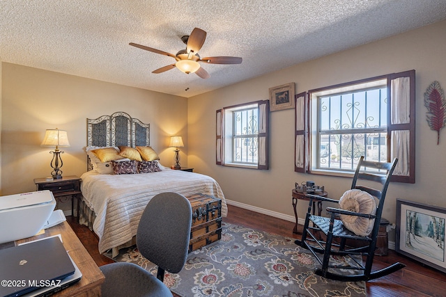 bedroom with baseboards, a textured ceiling, wood finished floors, and a ceiling fan