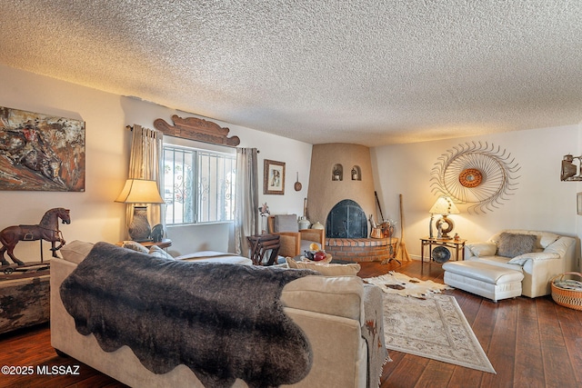 living room with dark wood-style floors and a textured ceiling