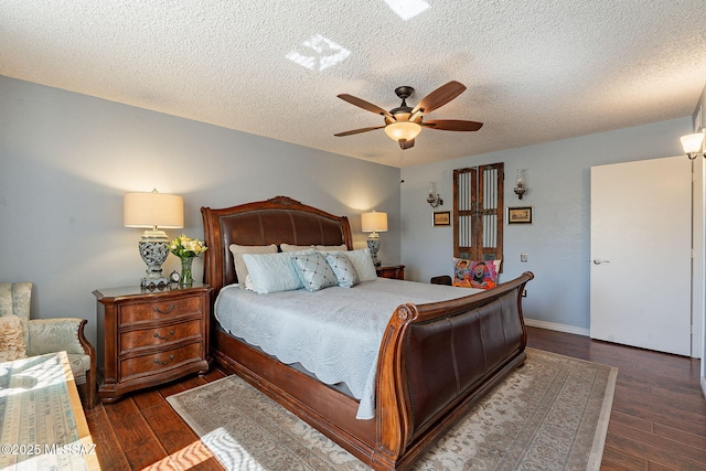 bedroom featuring dark wood-style floors, a textured ceiling, a ceiling fan, and baseboards